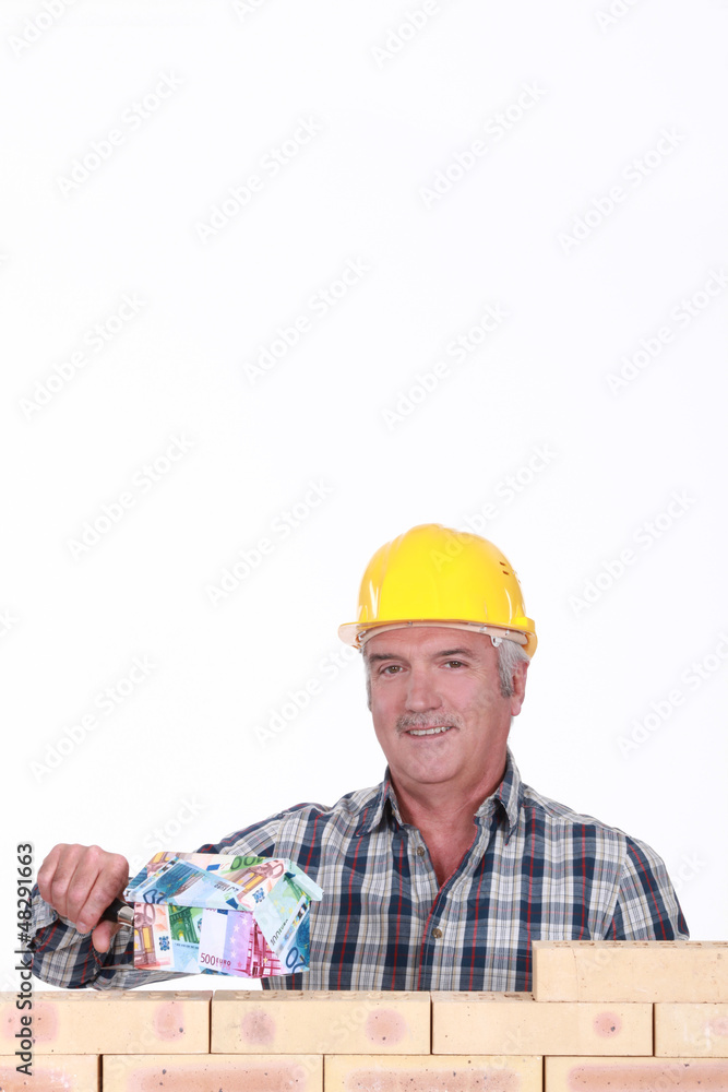 Builder with a house made of money Builder with a house made of money