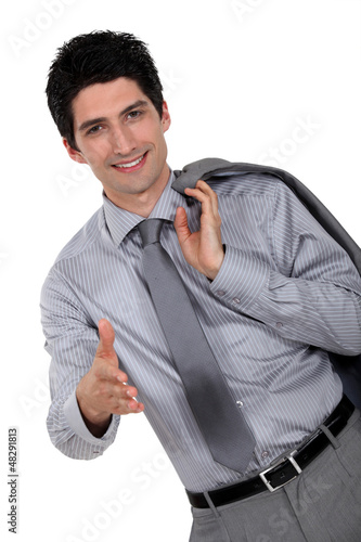 young businessman stretching out his hand to shake hands photo