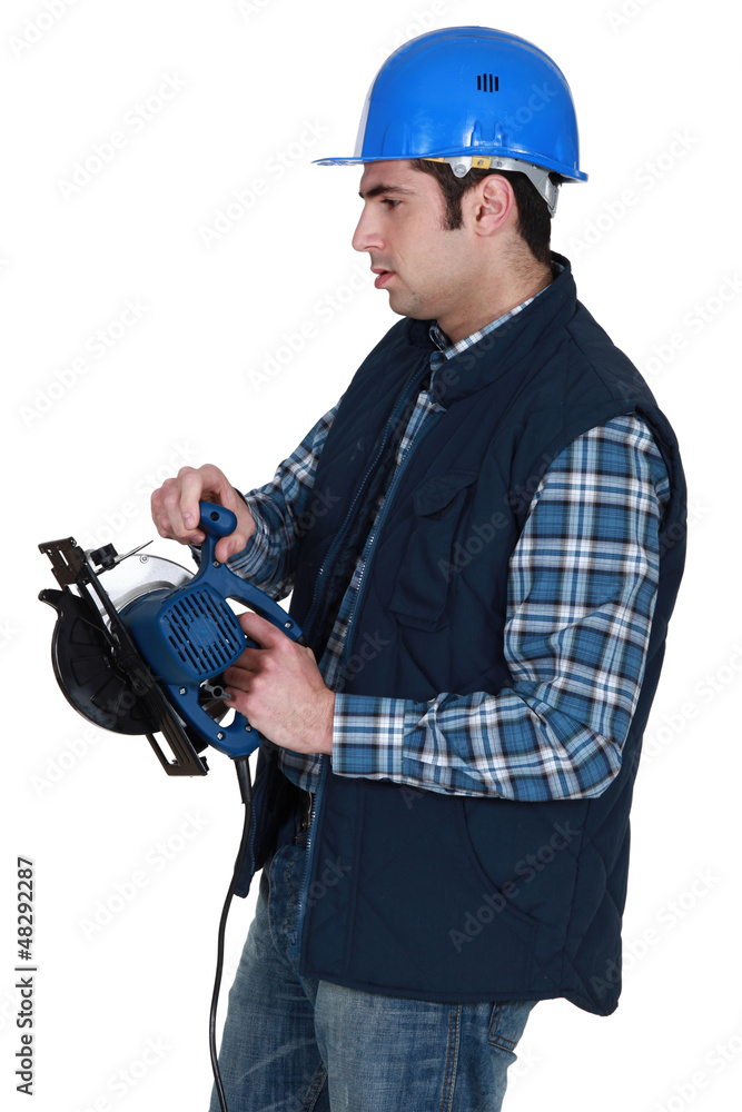 Man holding circular saw Man holding circular saw