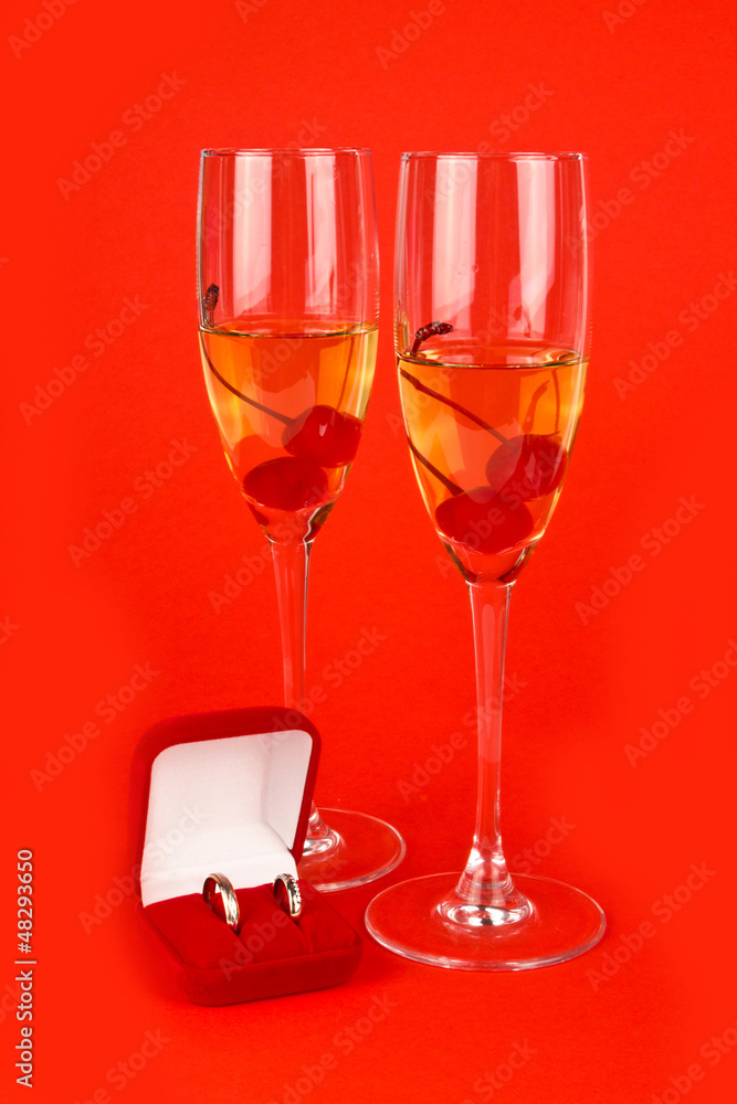 Two Valentine's champagne glasses with jewelery on red Two Valentine's champagne glasses with jewelery on red