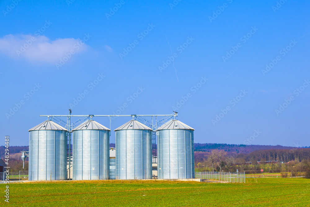 silver silos in field silver silos in field