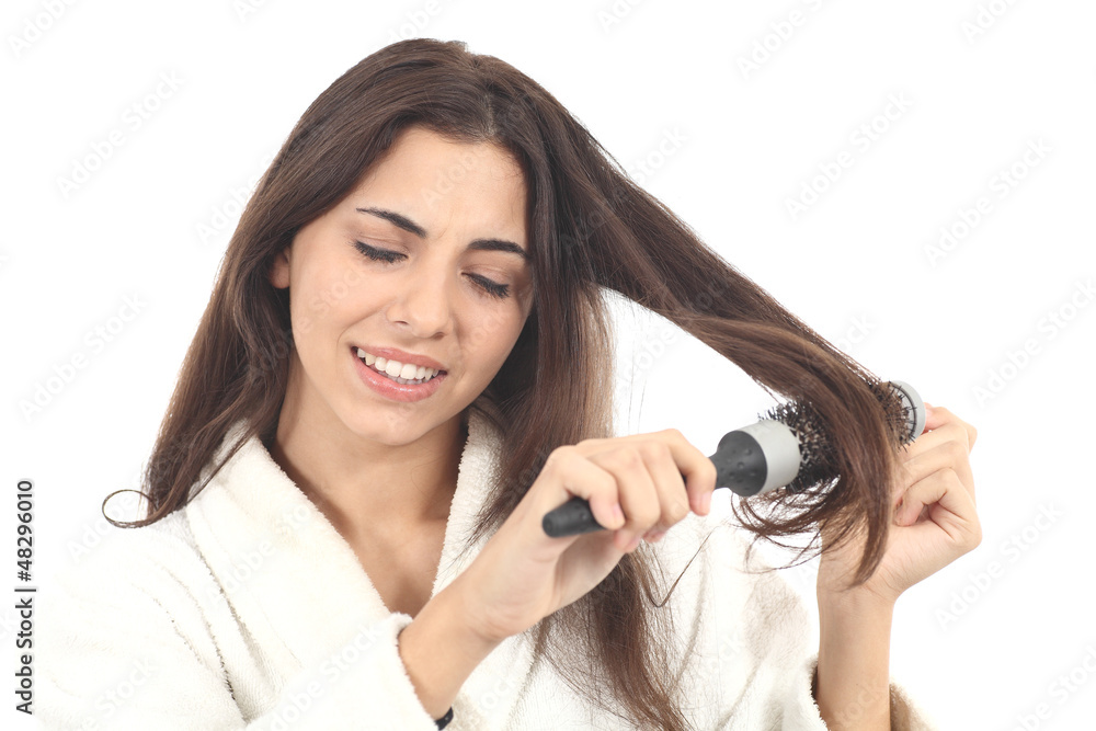 Fototapeta premium Woman suffering combing with the hairbrush
