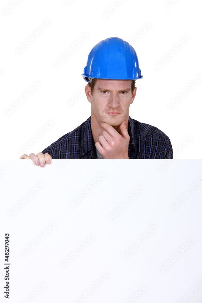 Bewildered workers behind white poster Bewildered workers behind white poster