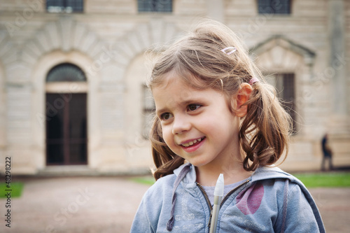 Smiling young girl close up portrait outdoors.