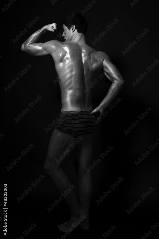 Full-length studio shot of strong handsome fitness sportsman, sh Full-length studio shot of strong handsome fitness sportsman, sh