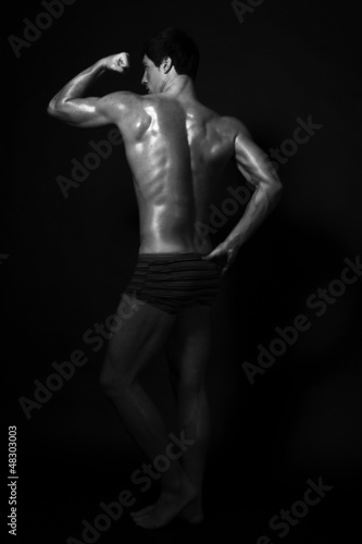 Full-length studio shot of strong handsome fitness sportsman, sh