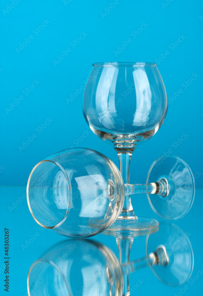 Two empty wine glasses on color background Two empty wine glasses on color background