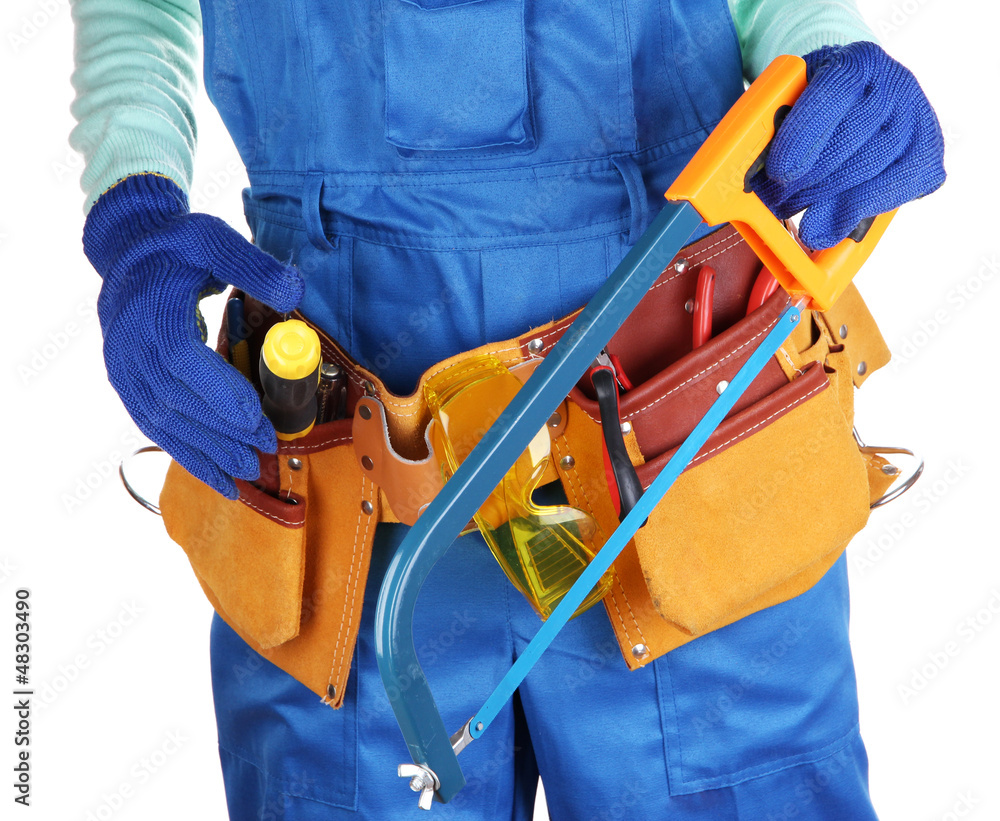 Male builder in blue overalls with saw isolated on white Male builder in blue overalls with saw isolated on white