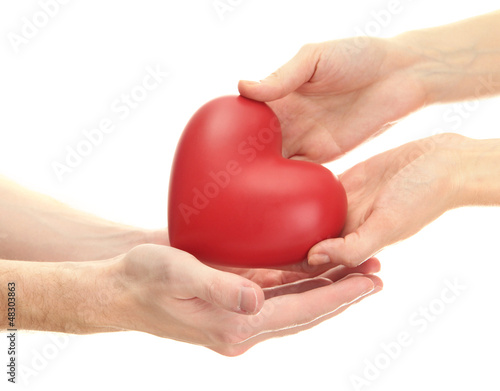 Red heart in woman and man hands  isolated on white