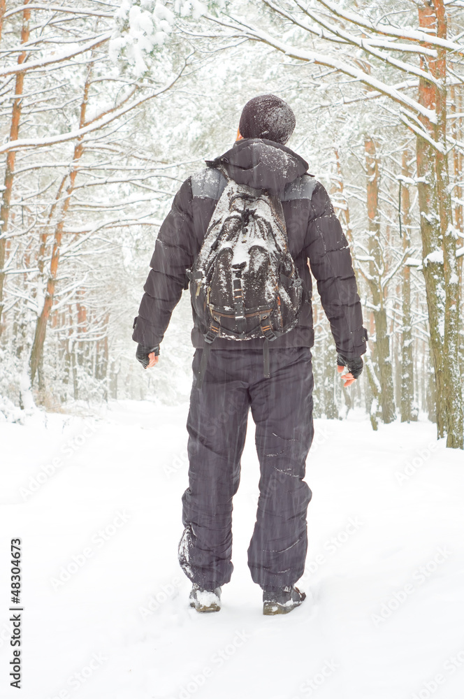 The man walking in winter forest The man walking in winter forest