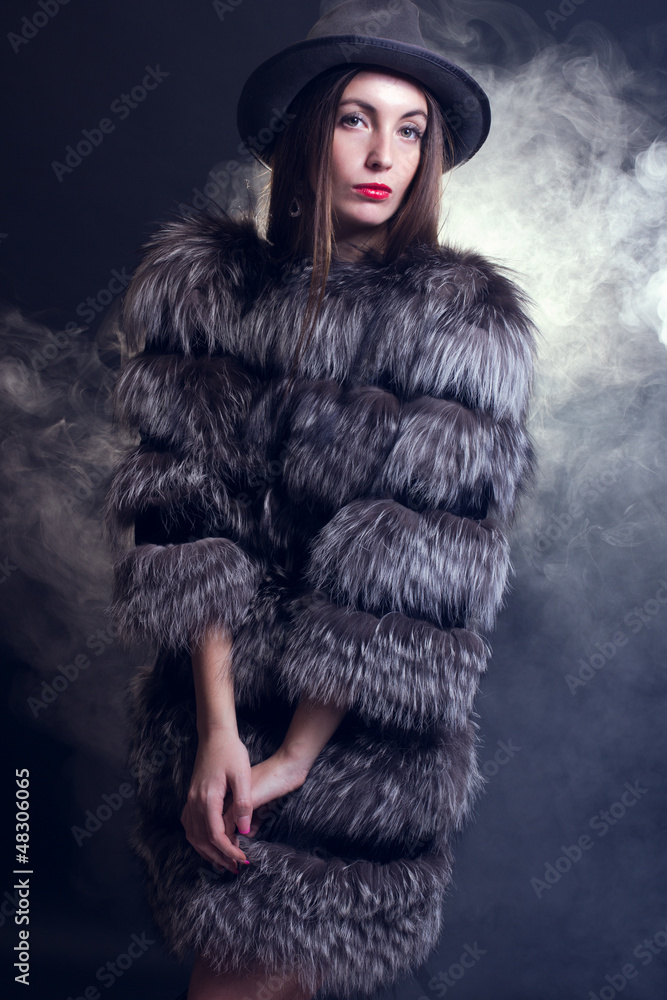 young woman in a fur coat and hat. young woman in a fur coat and hat.