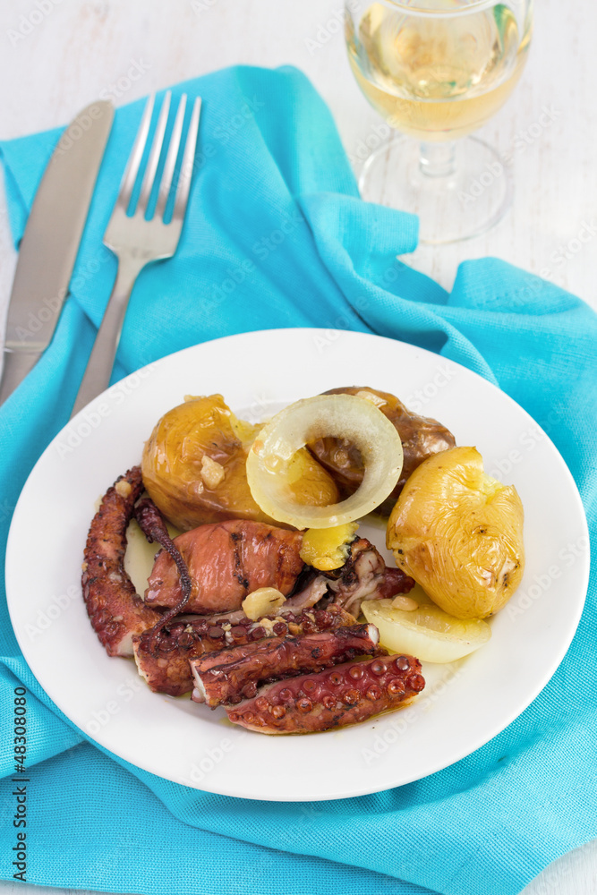 octopus with potato and oil on the plate