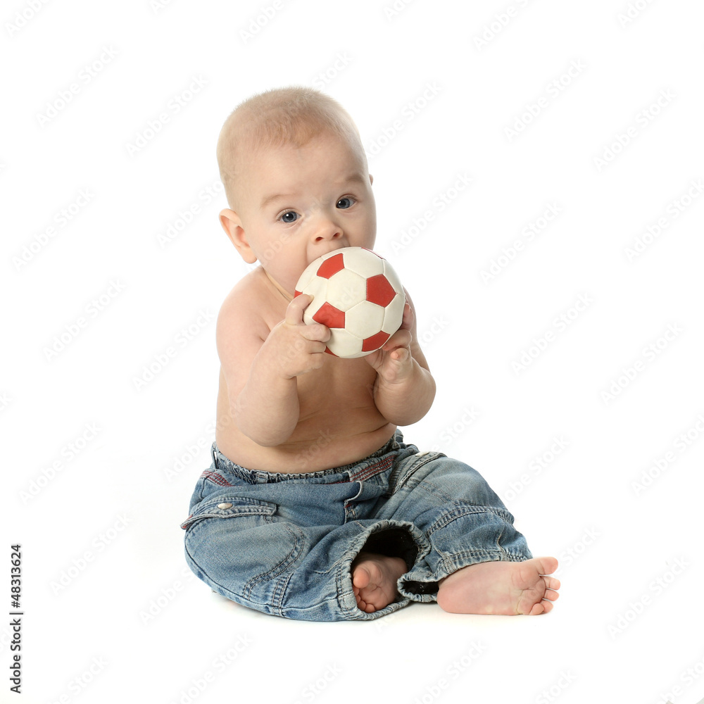 Small baby boy with a ball in jeans Small baby boy with a ball in jeans