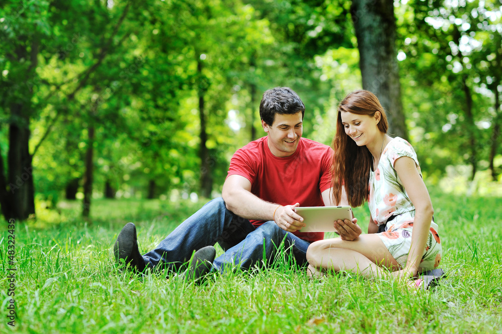 Cheerful couple using digital tablet