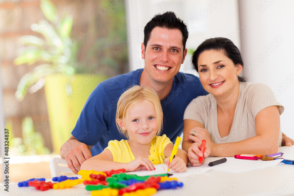 happy parents and little daughter drawing pictures at home happy parents and little daughter drawing pictures at home