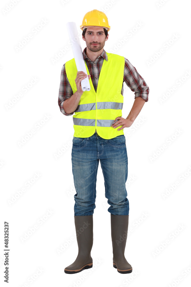 Engineer in a reflective vest with plans