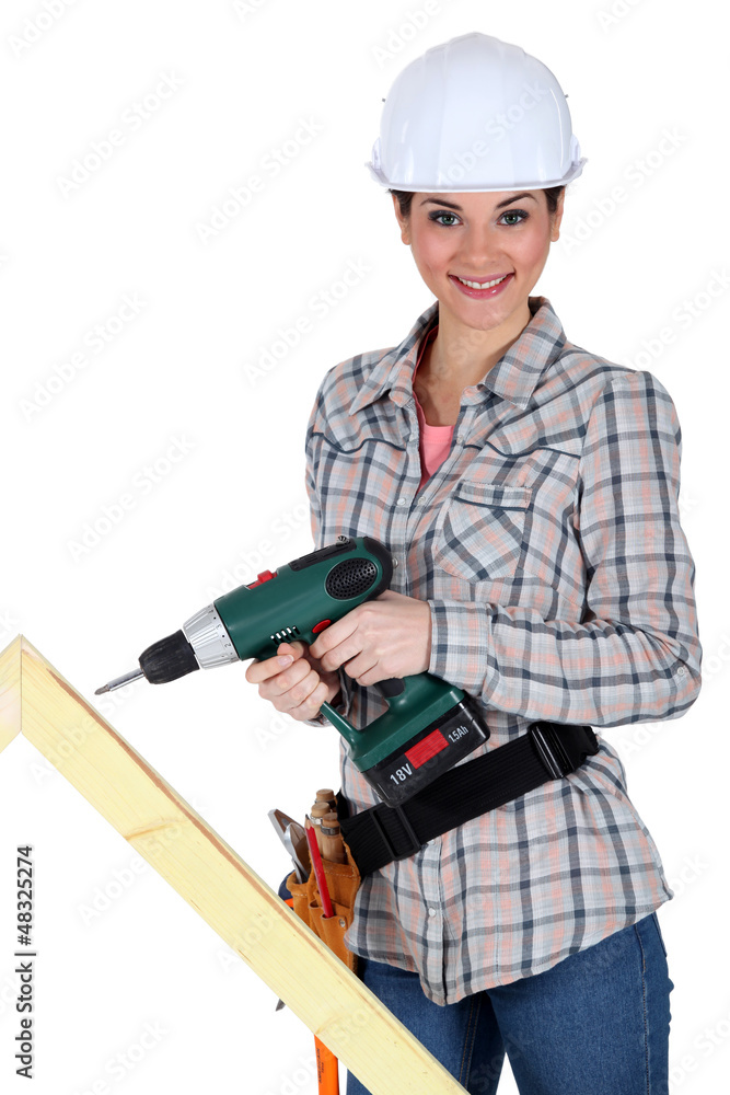 Woman drilling into plank of wood Woman drilling into plank of wood