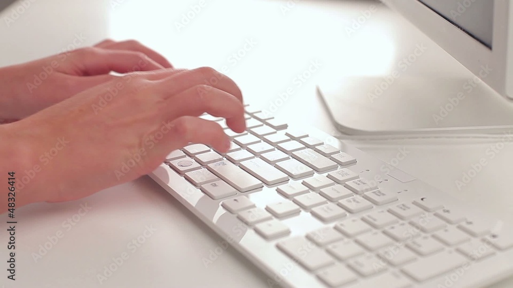 young woman typing on a keyboard young woman typing on a keyboard