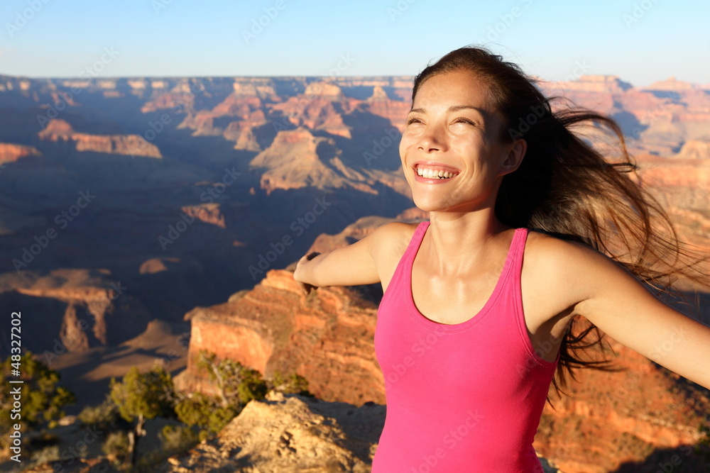 Happy freedom woman in Grand Canyon