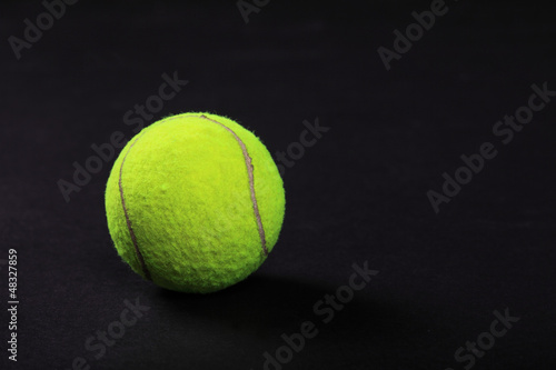 tennis balls on black background studio shot