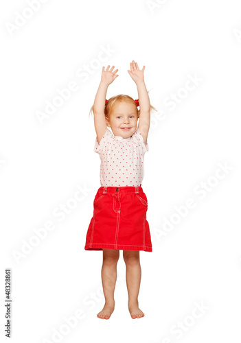 Happy child lifting up her hands.