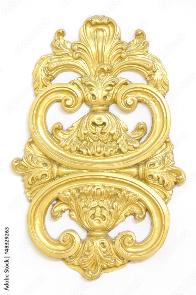 of an ancient gold ornament on a white background