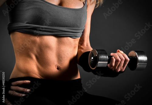 Fit woman abdomen muscle definition photo