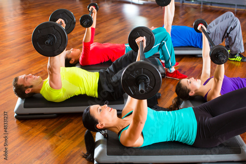 Canvas Print weight training in the gym with dumbbells