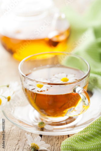 cup of herbal tea with camomile flowers