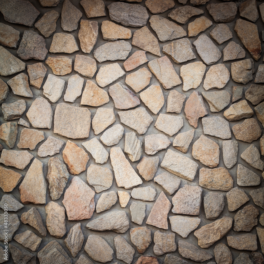Square shot of a wall from stones Square shot of a wall from stones