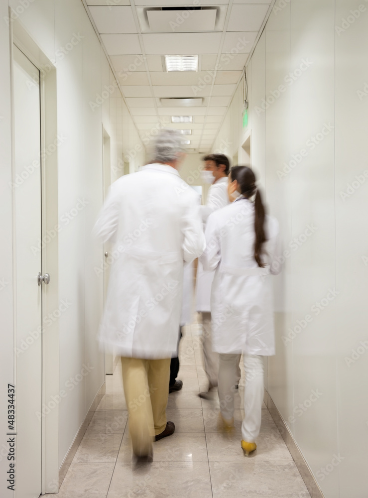 Medical Professionals Walking In Corridor Medical Professionals Walking In Corridor