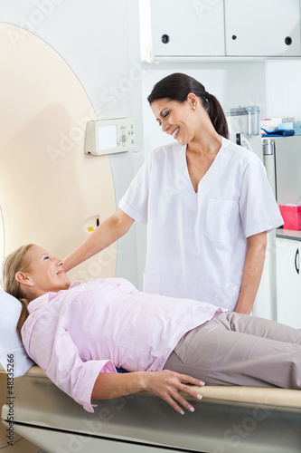 Radiologic Technician Looking At Patient