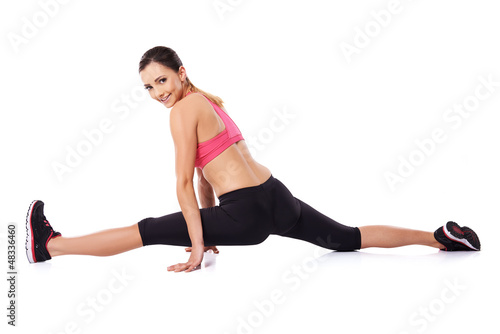 Pretty smiling woman doing the splits