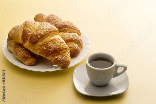 Cup of coffee with croissants