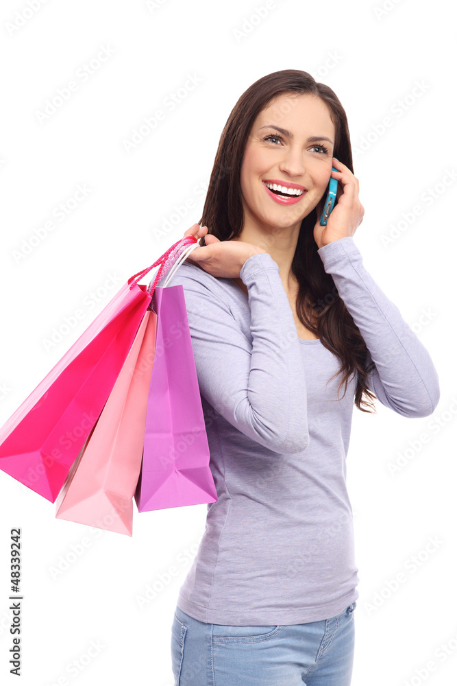 Woman with mobile phone and shopping bags