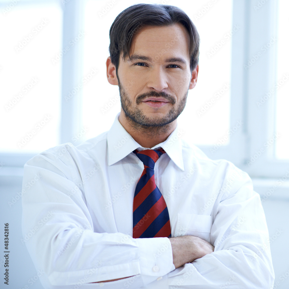 Handsome man standing with folded arms Handsome man standing with folded arms