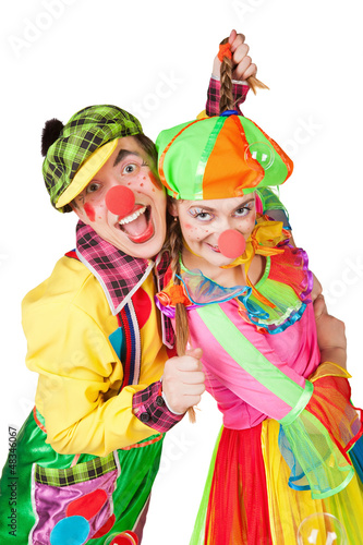 Two clown smiling isolated over a white background