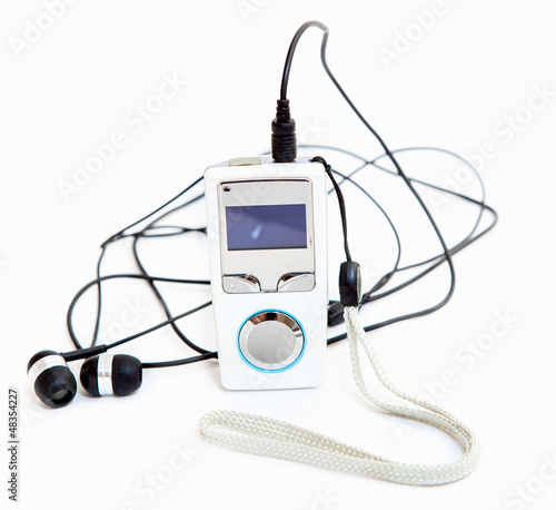 Mp3 player with headphones on white background photo