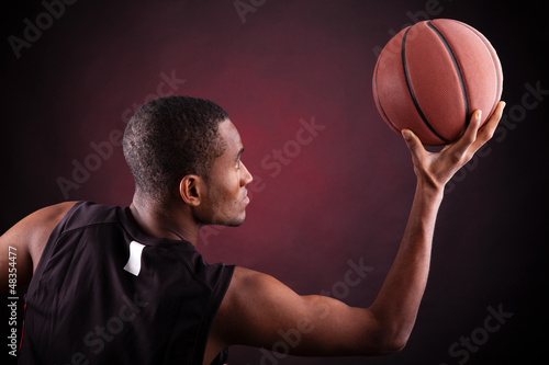 Male basketball player against black background © cristovao31
