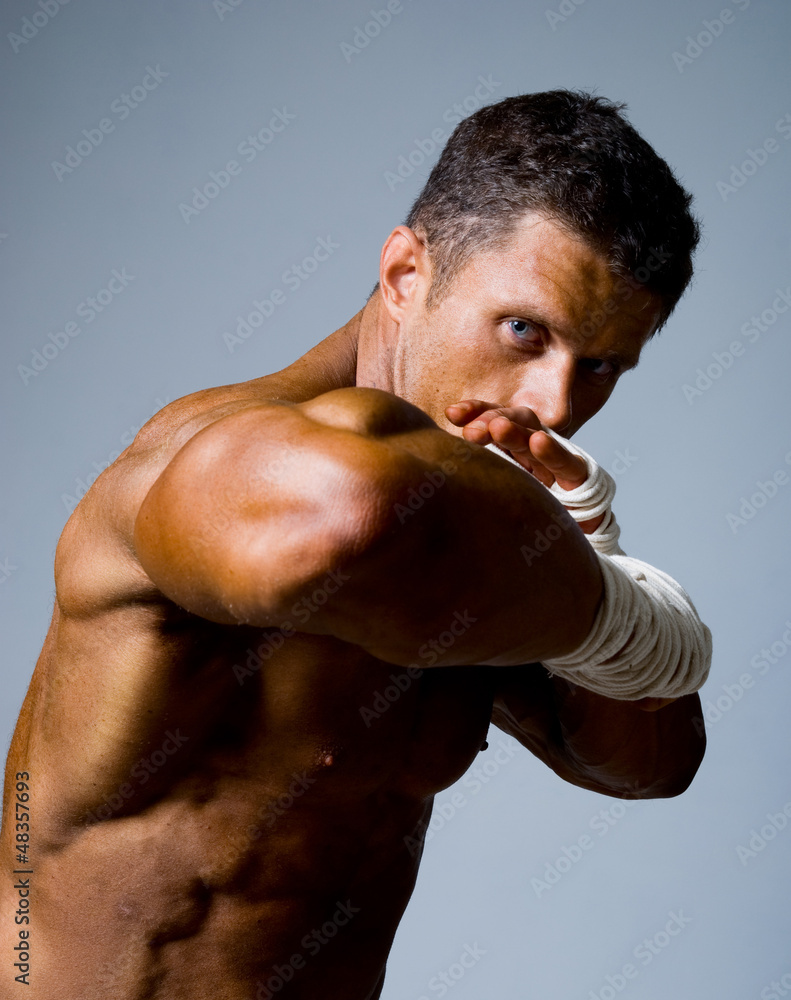 Close-up portrait of a kick-boxer in a fighting stance.