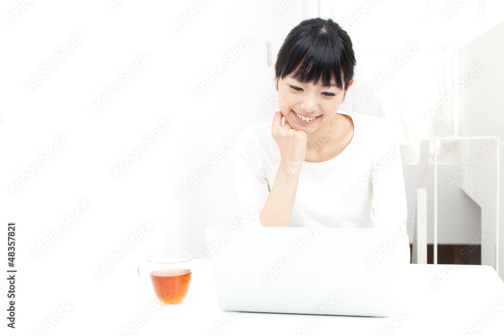 a young asian woman using laptop computer