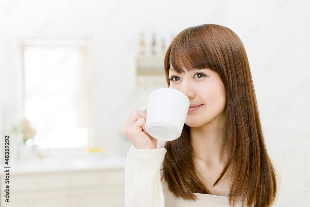 Beautiful asian woman in the kitchen