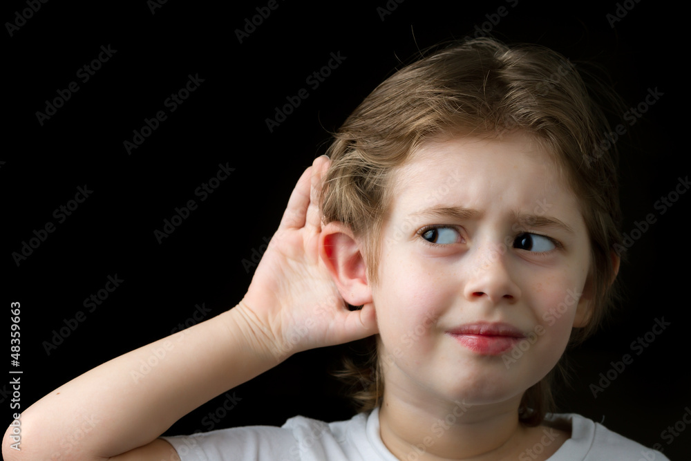 Fototapeta premium Boy listening with hand on an ear