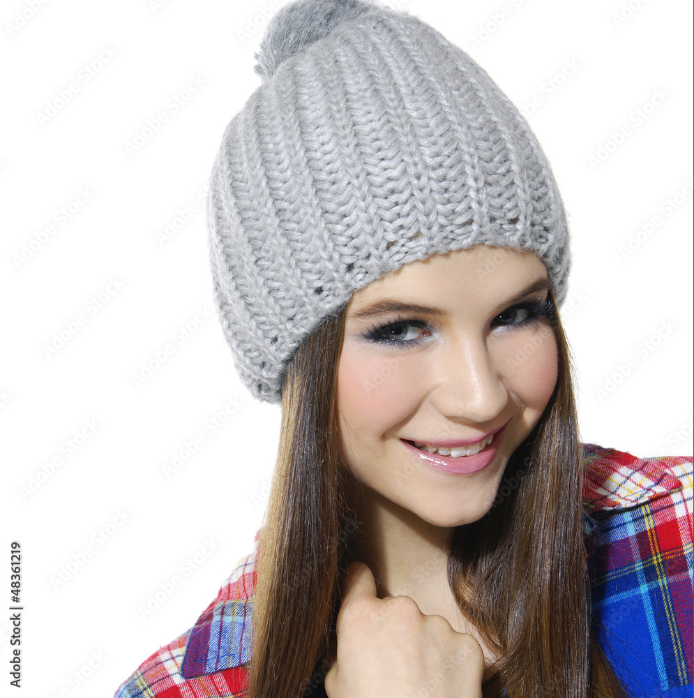 Close up of young woman with winter cap smiling