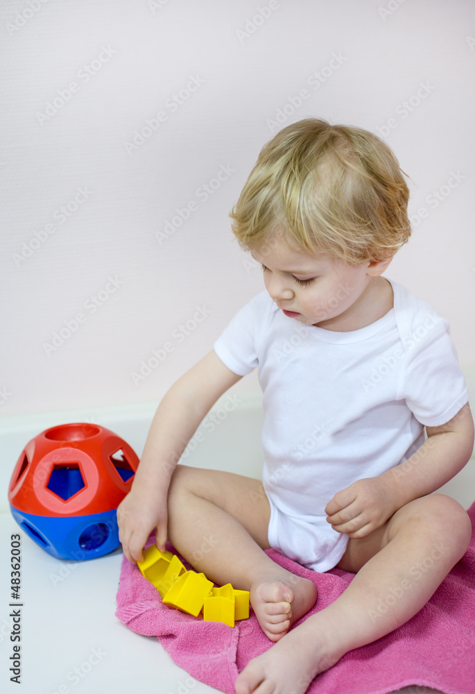 Little toddler boy playing with puzzle toys Little toddler boy playing with puzzle toys