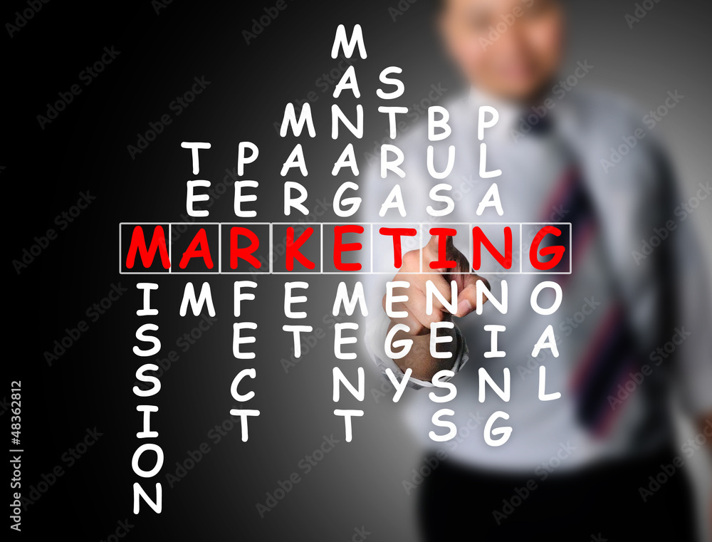 Business man touching marketing crossword Business man touching marketing crossword