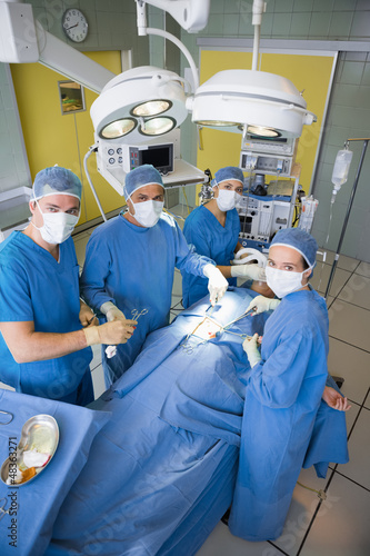 Surgery team looking at camera during operation
