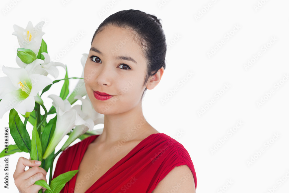 Woman standing while holding flowers