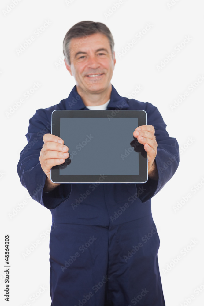 Mature mechanic showing digital tablet