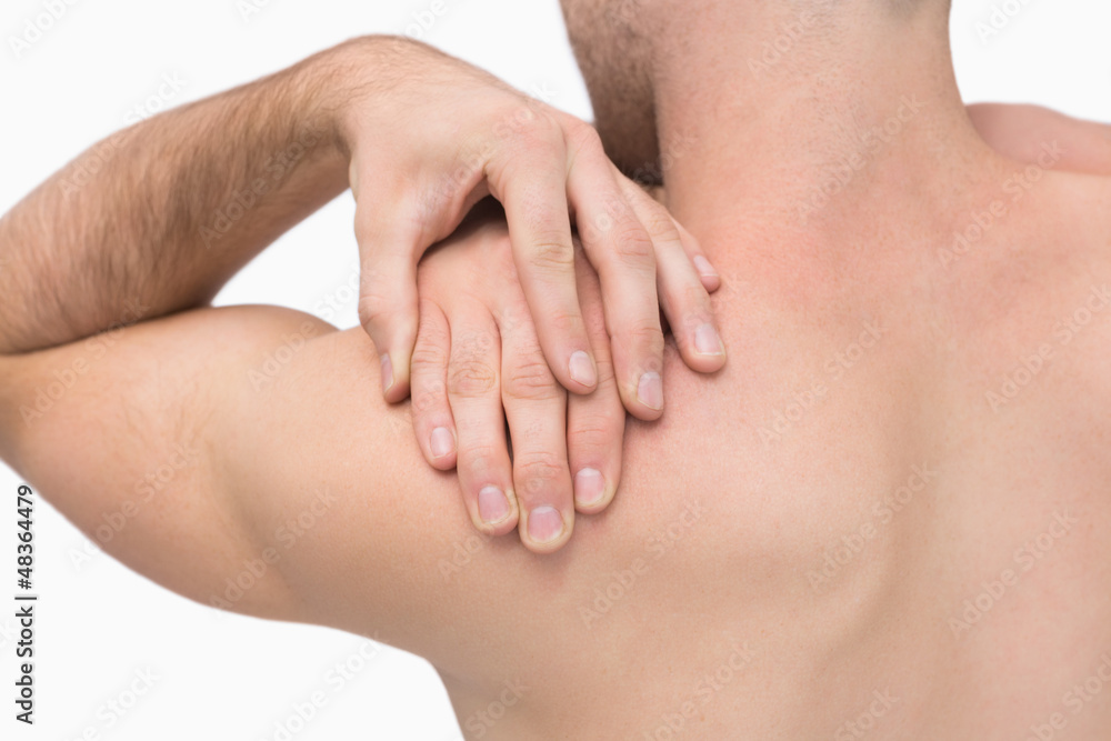 Rear view of shirtless man with shoulder pain Rear view of shirtless man with shoulder pain